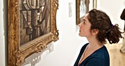 Admiring an exhibit woman looking a painting